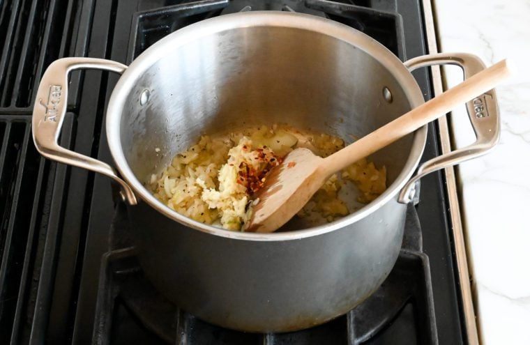 adding garlic and red pepper flakes