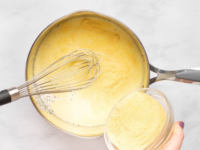 whisking polenta into milk mixture.