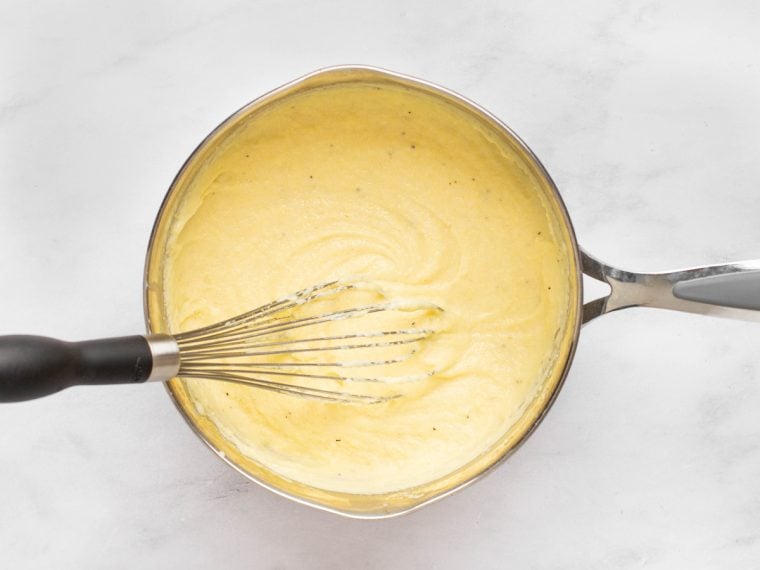 whisking polenta as it cooks.