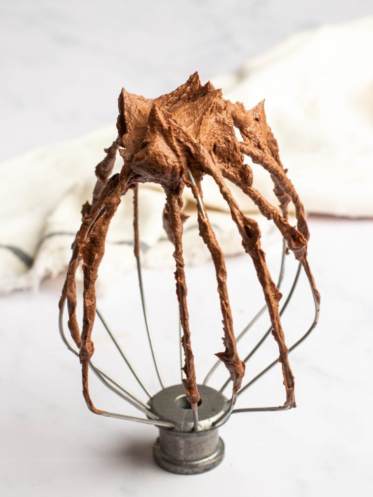 Electric mixer beater topped with whipped ganache.