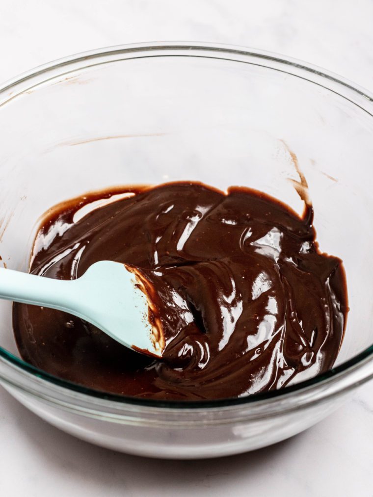 Spatula in a bowl of chocolate ganache.