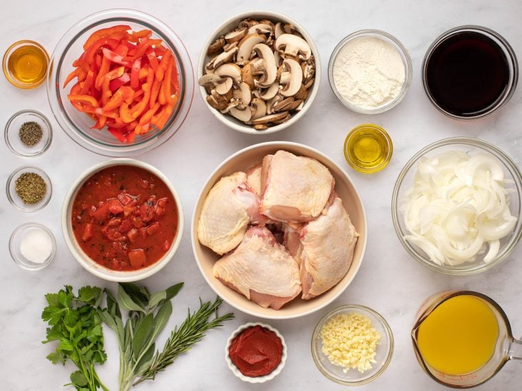 Chicken ingredients including mushrooms, herbs, and sliced red peppers.