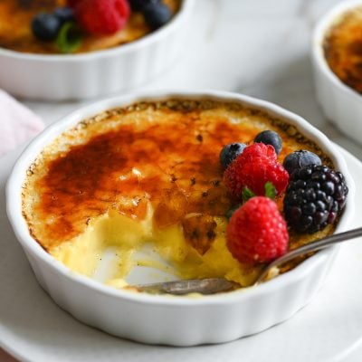 Spoon in a partially-eaten creme brulee.