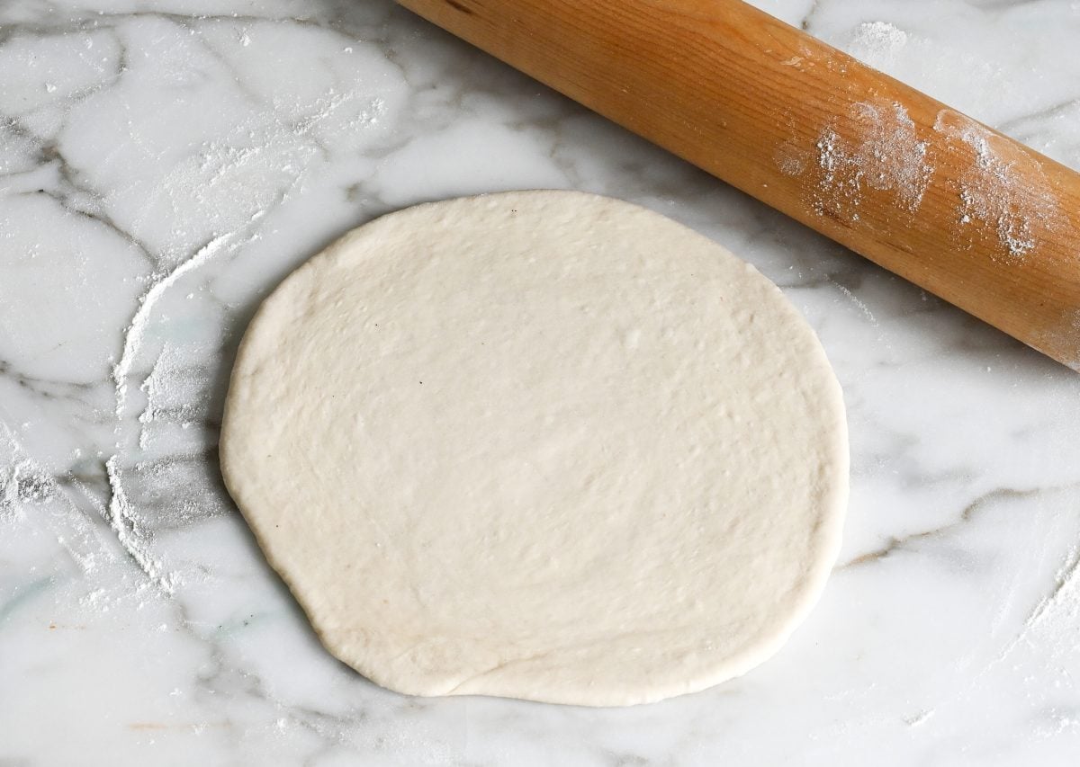 rolling out the calzone dough