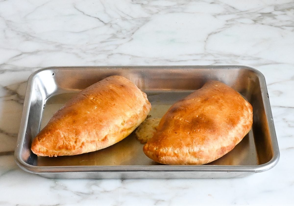 calzones fresh out of the oven on baking sheet