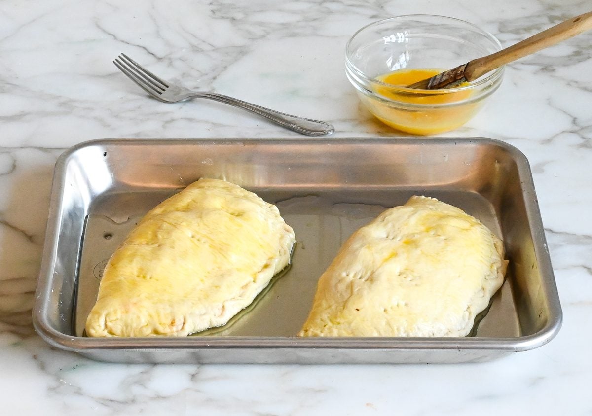 calzones brushed with egg wash and pricked with fork