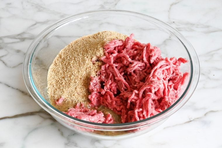 adding the meatloaf mix and bread crumbs to the egg mixture