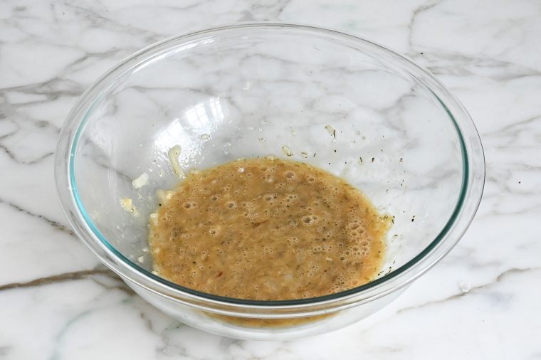 whisked egg and onion meatloaf mixture in bowl