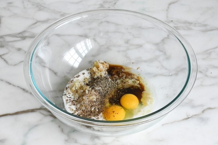 adding the milk, eggs, thyme, salt, pepper, and Worcestershire sauce to the bowl