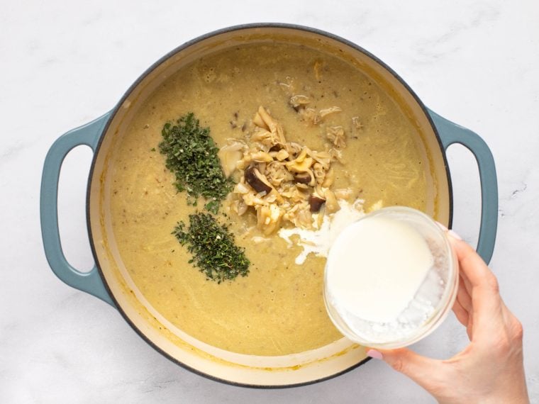 adding the cream, mushrooms and herbs to the cream of mushroom soup