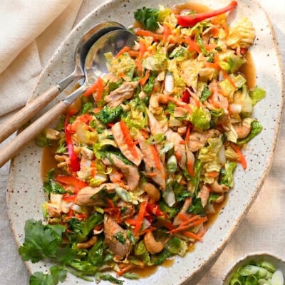 Chinese chicken salad on platter with serving spoons