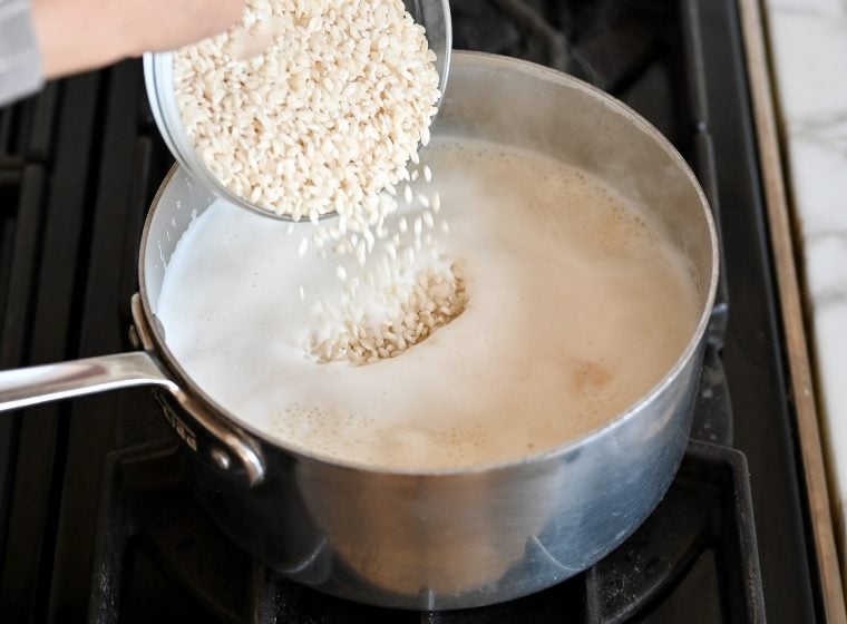adding rice to boiling milk mixture.