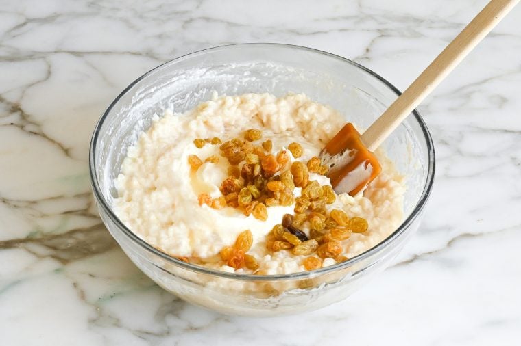 folding steeped raisins and creme fraiche into rice pudding