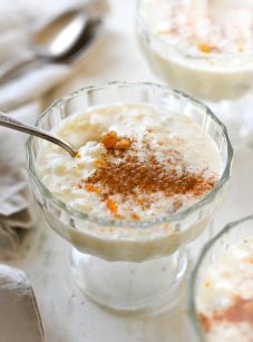 Spoon in a stemmed glass of rice pudding.