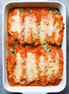 Spinach manicotti in a baking dish.