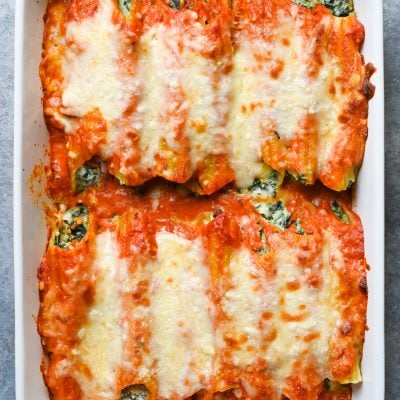 Spinach manicotti in a baking dish.
