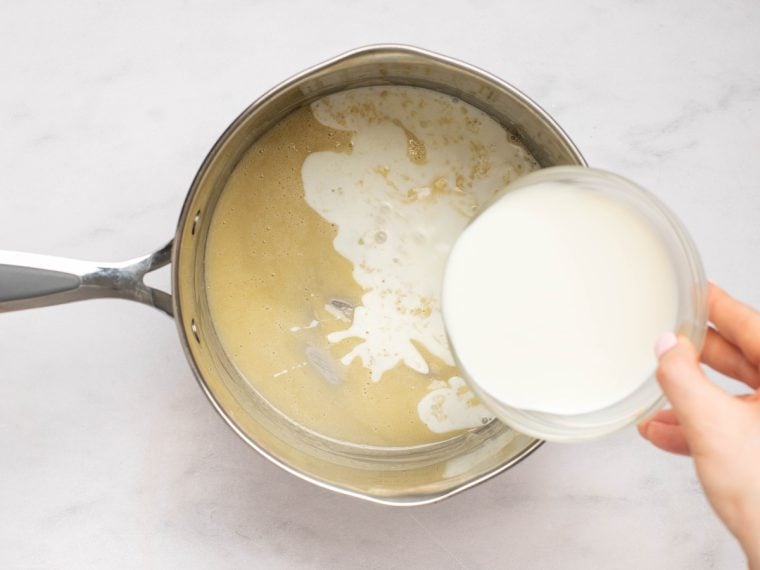 adding the milk to the flour and butter mixture