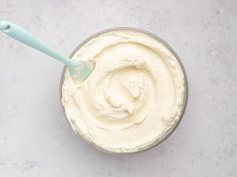 Spatula in a bowl of Swiss meringue buttercream.