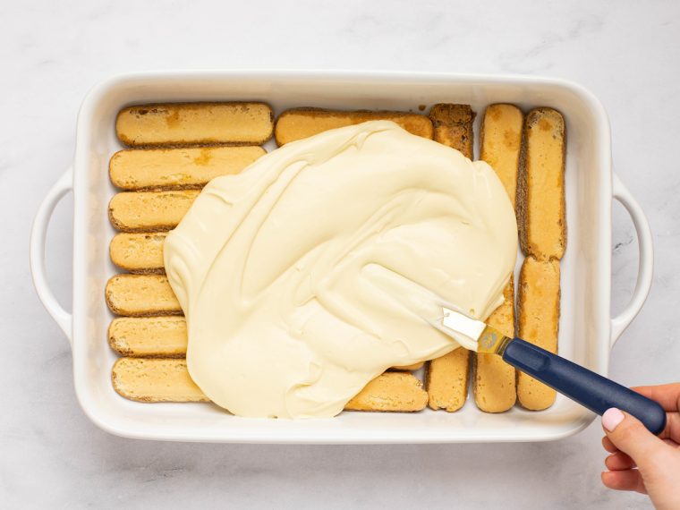 spreading the mascarpone mixture over the ladyfingers