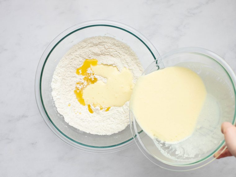 adding the buttermilk mixture and melted butter to the dry ingredients.
