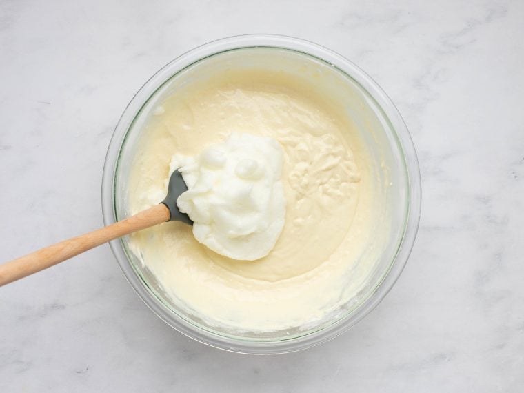 adding the beaten egg whites to the waffle batter.