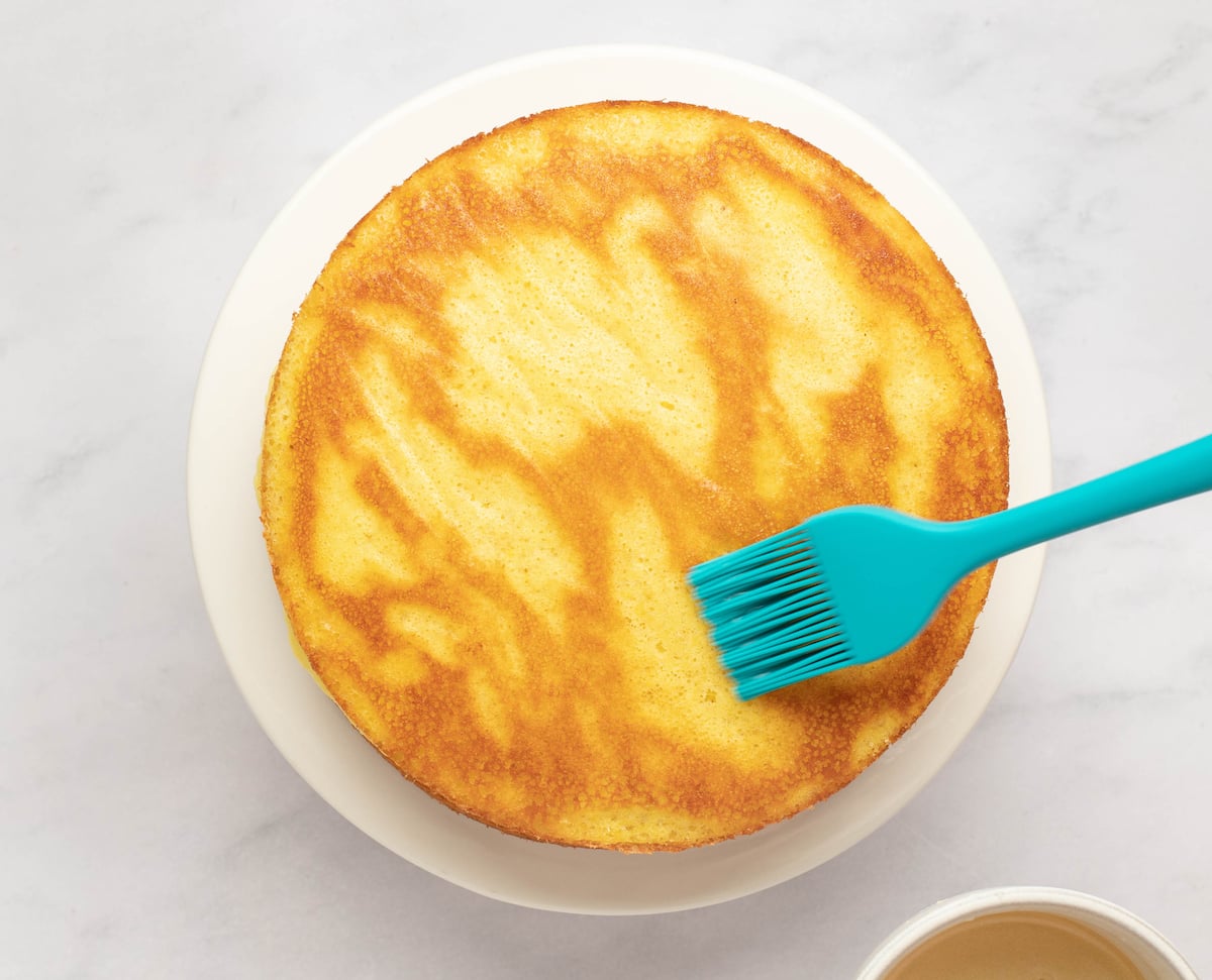 spreading soaking syrup on top layer