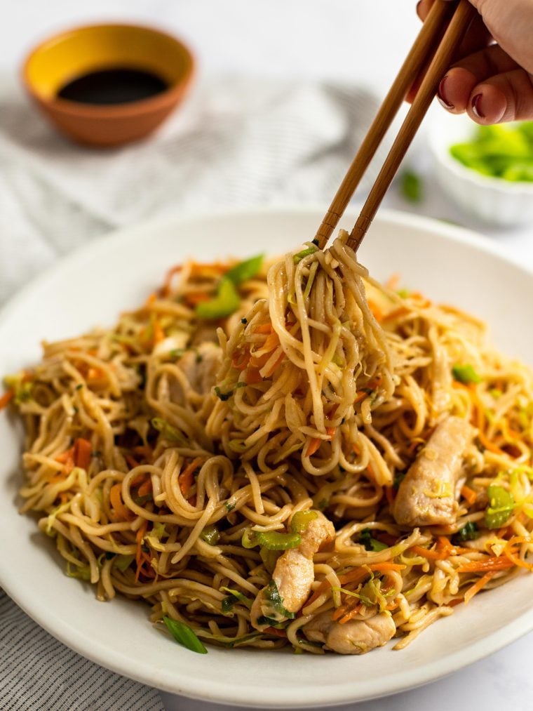 chicken chow mein on plate with chopsticks