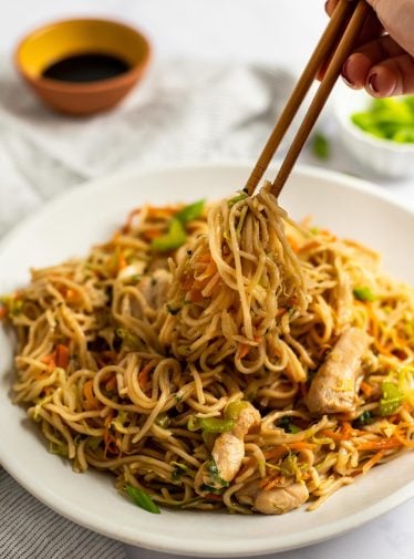chicken chow mein on plate with chopsticks