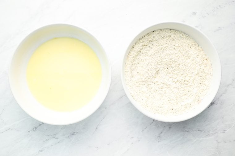 whisked egg in one bowl and whisked flour, cornstarch, baking powder, garlic powder, pepper, Accent, paprika, and the remaining salt in second bowl