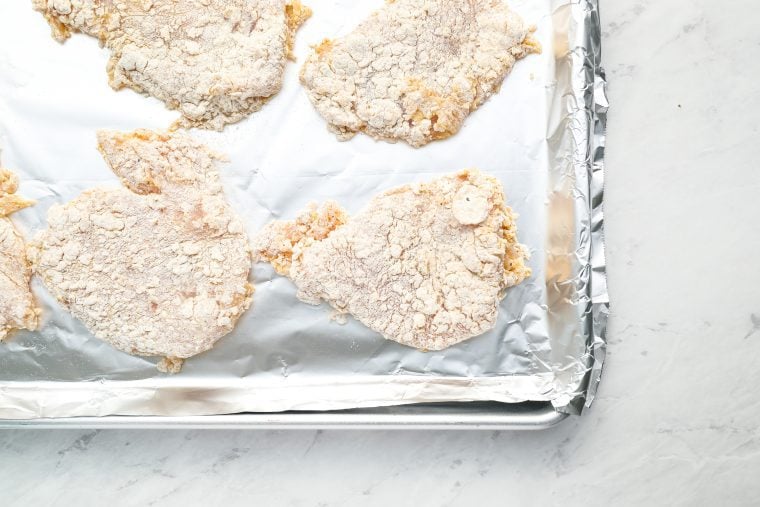 breaded chicken on baking sheet