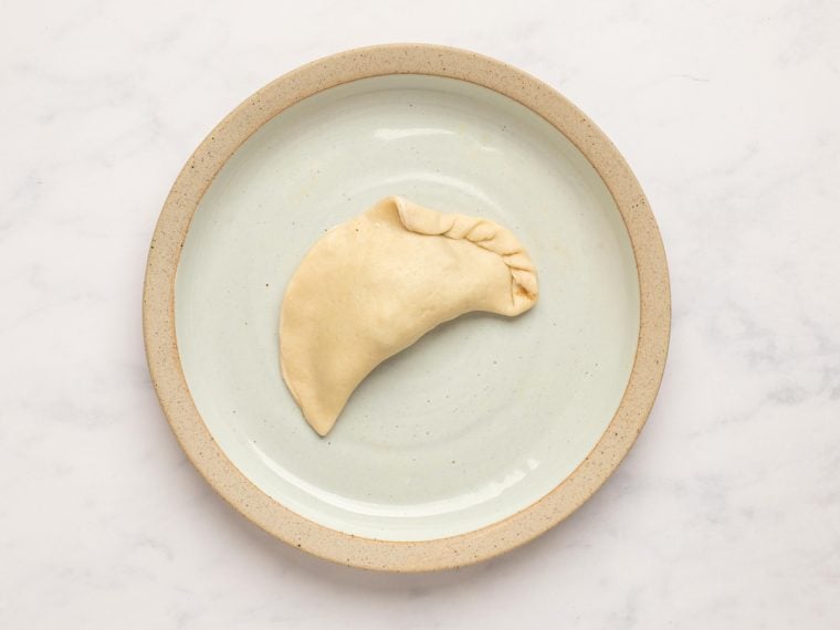 pinching and twisting pastry into rope-like shape