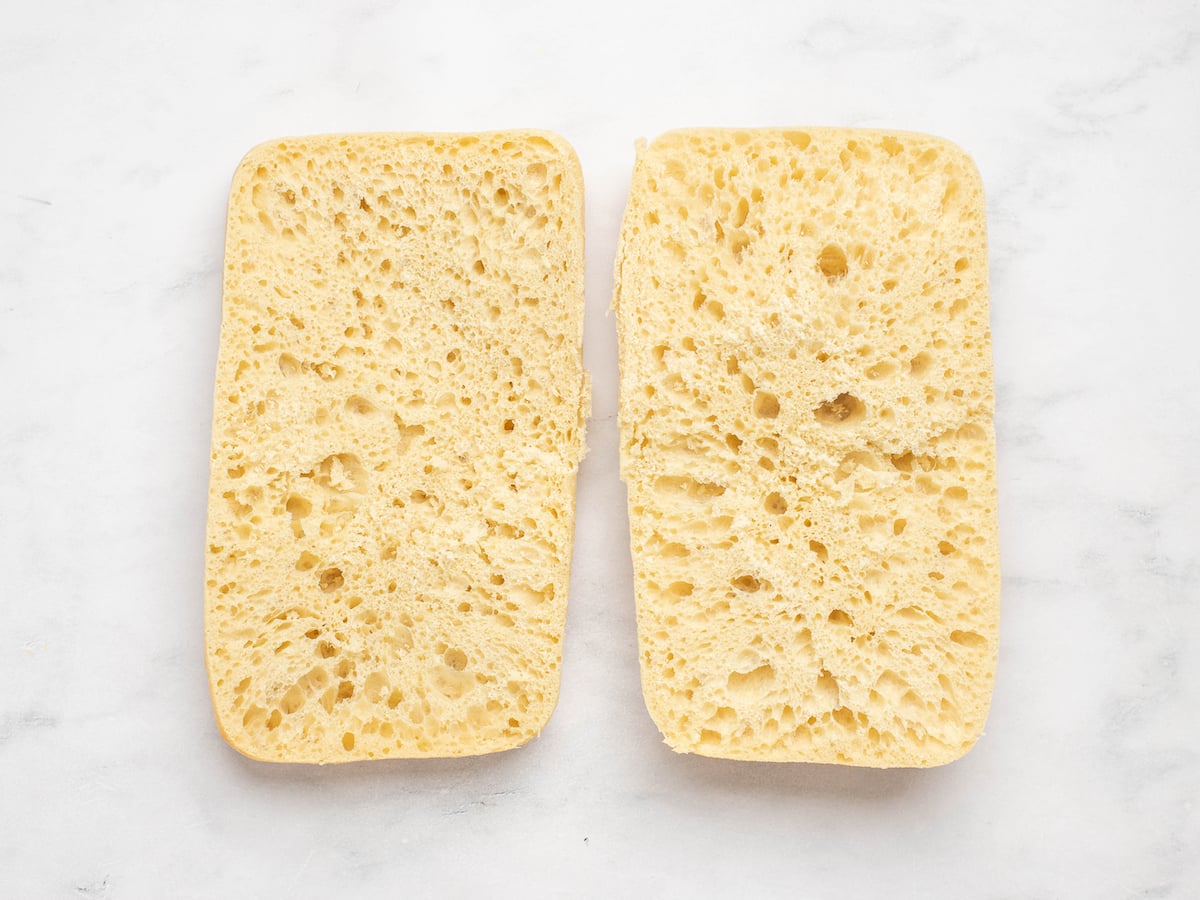 Sliced ciabatta on a marbled surface.