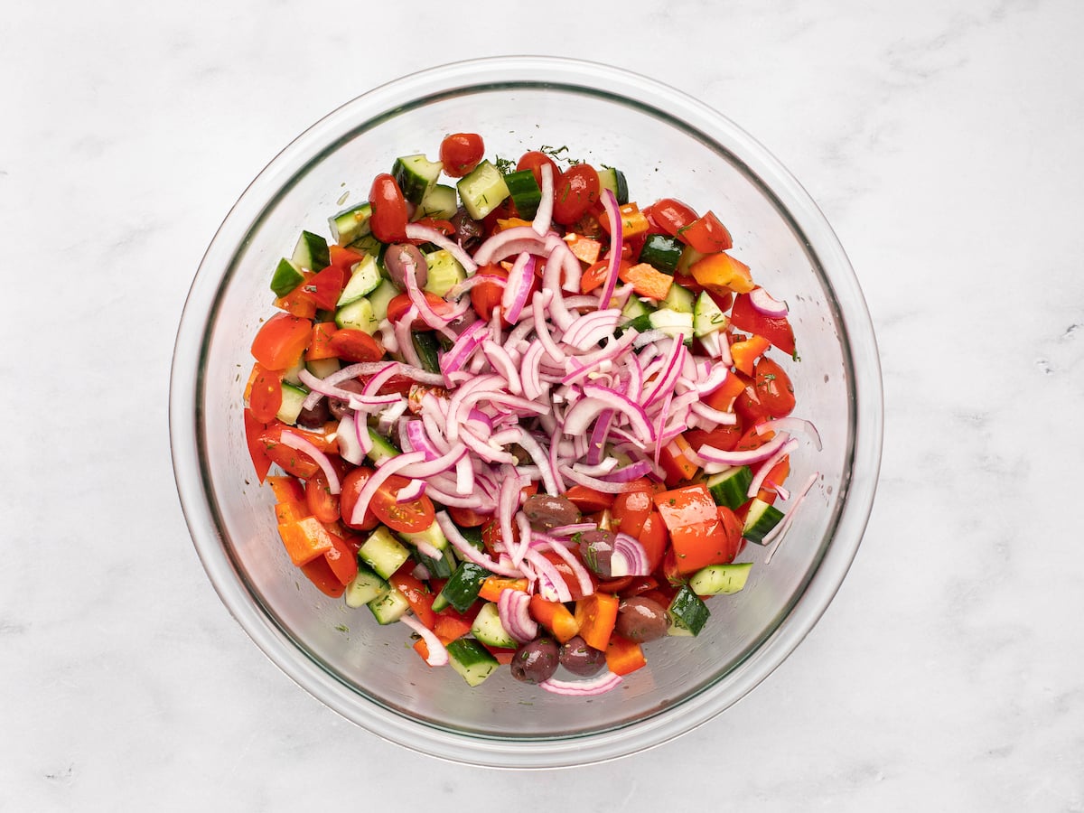 Pickled red onions added to the bowl.