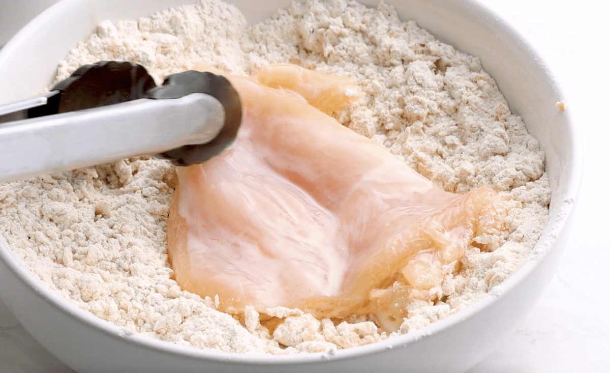 dredging the chicken in the flour mixture