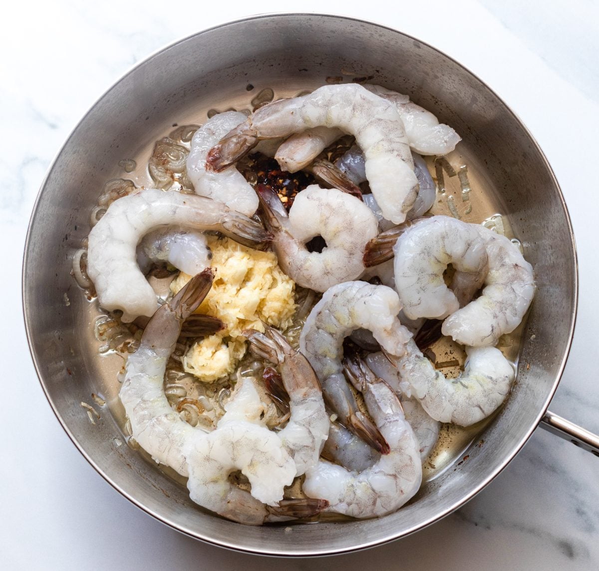 adding the shrimp to the skillet