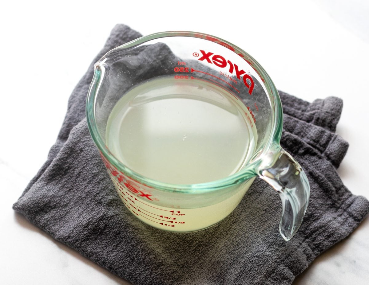 reserved pasta water in glass measuring cup