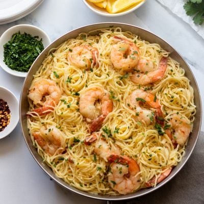 Shrimp scampi with noodles in a large bowl.