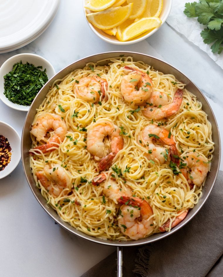 Shrimp scampi with noodles in a large bowl.