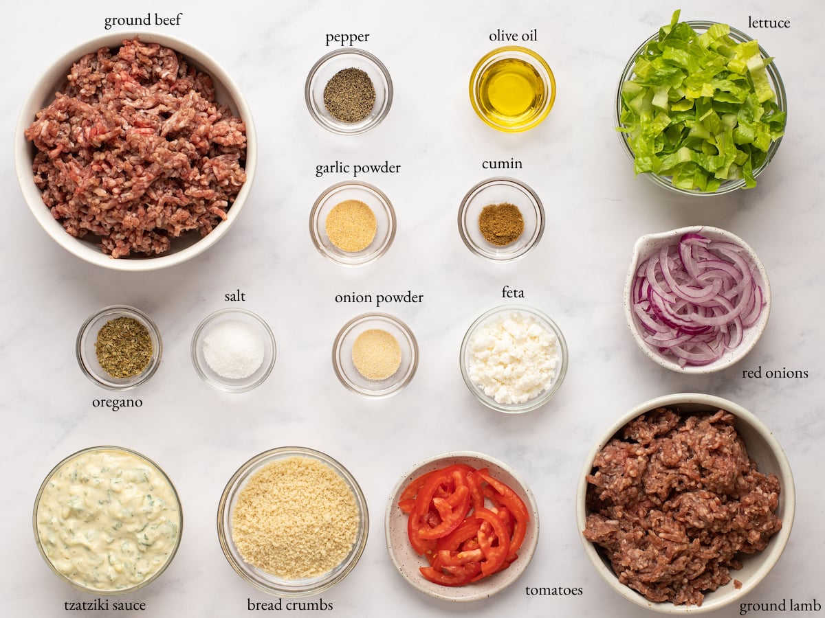 Ingredients to make homemade gyros in bowls and labeled to identify each one.