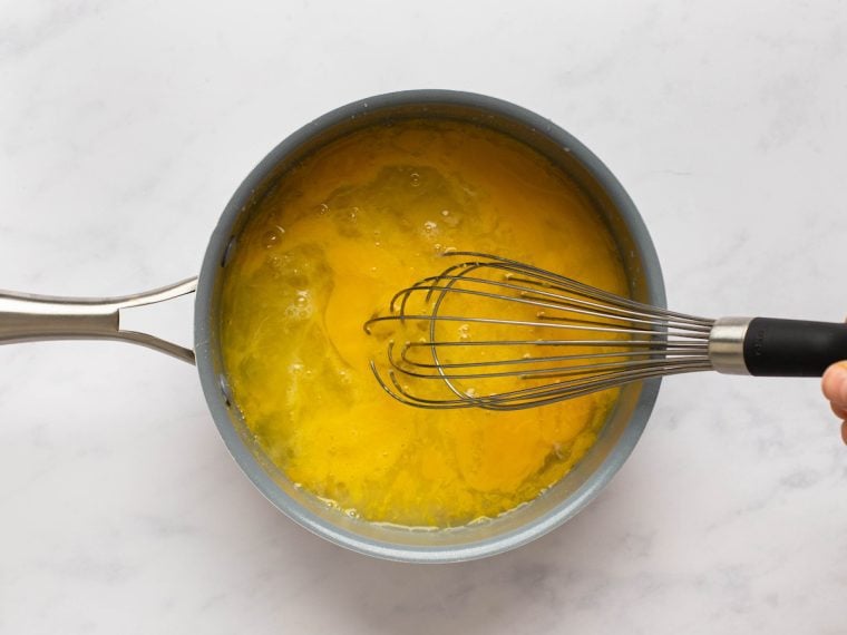 whisking sugar, eggs, lemon zest, lemon juice, and salt together