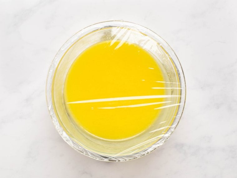lemon curd in bowl, covered with plastic wrap
