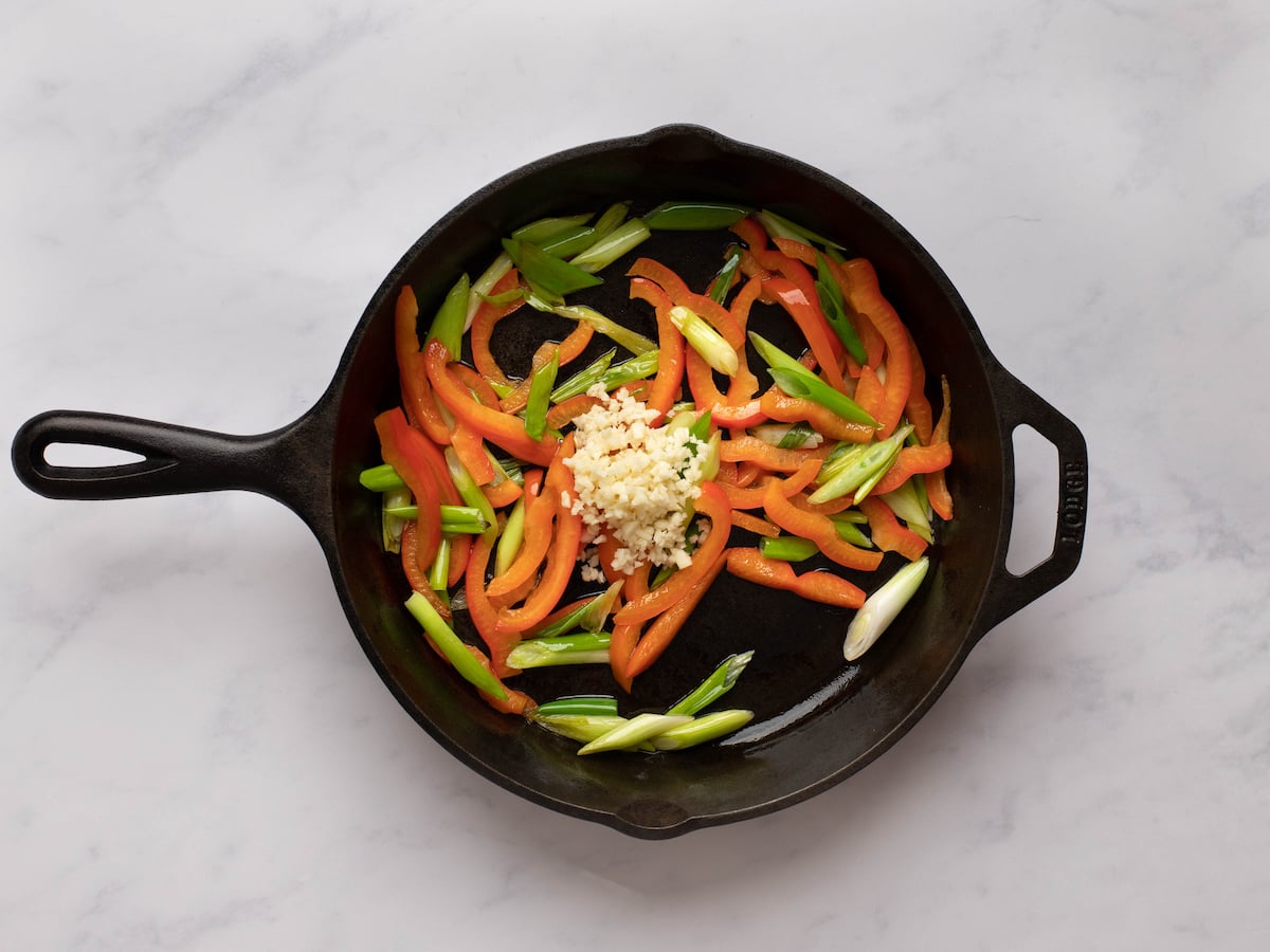 garlic added to pan with scallions and bell peppers