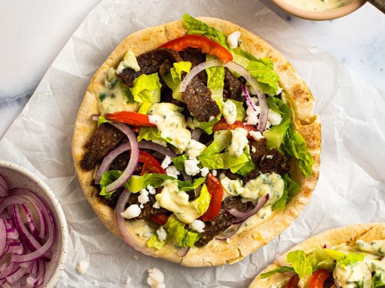 Gyros assembled on a piece of parchment paper.
