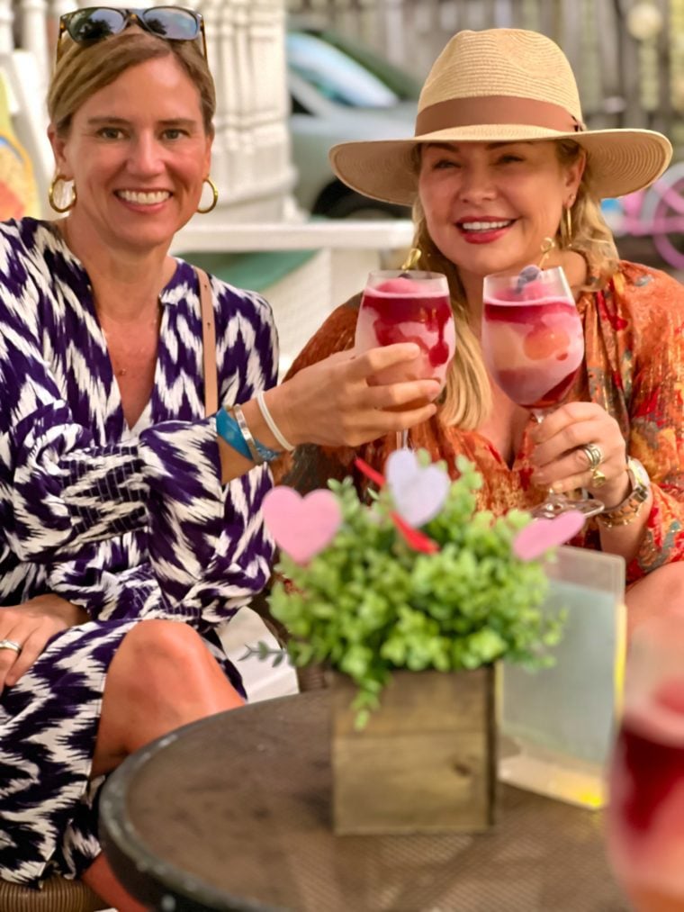 Two women, Katie and Sasha, sipping frosé at Grand Vin Wine Bar.