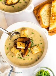 bowls of mushroom soup with bread