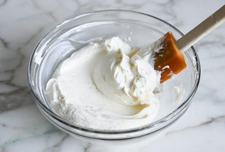 stirring labneh in bowl