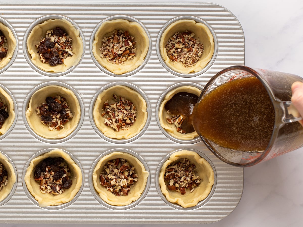 pouring filling into muffin cups