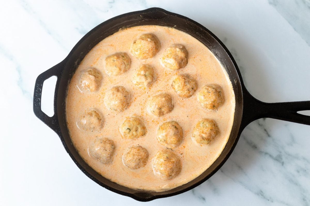 meatballs simmering in Buffalo cream sauce
