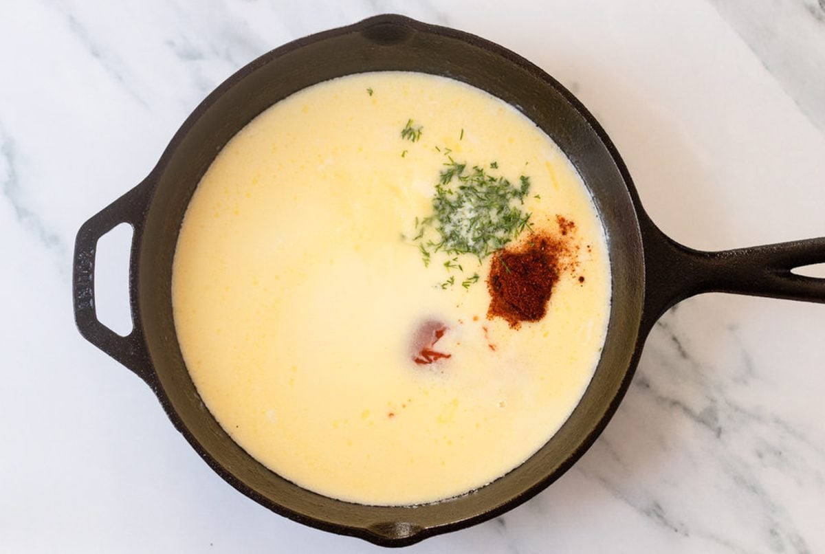 adding spices and herbs to buffalo cream sauce
