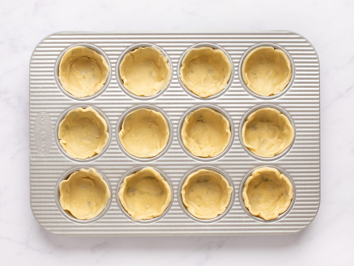 Butter tart dough in muffin tin.